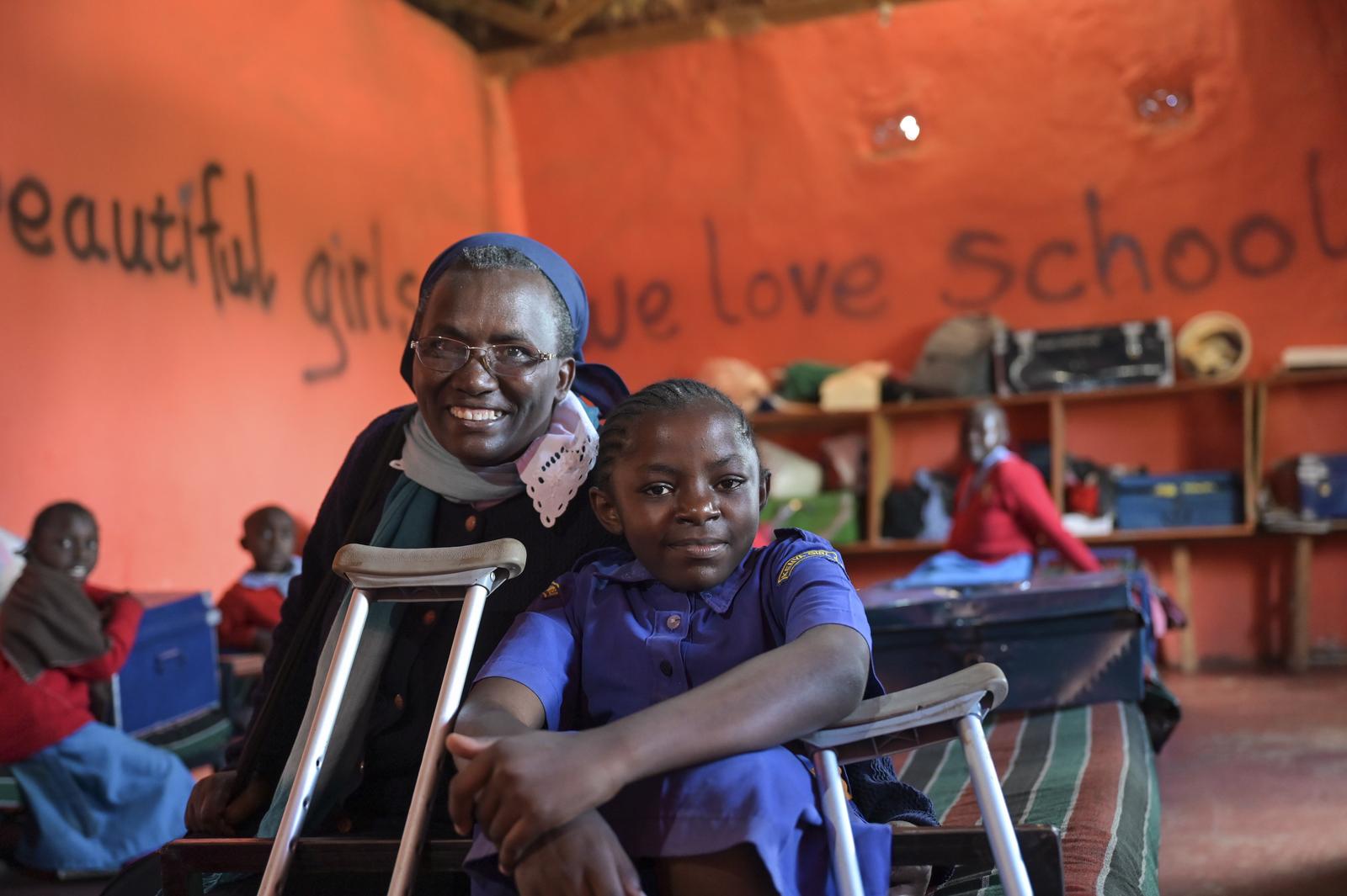 Schwester Pauline mit Esther, einem Mädchen mit Behinderung. Beide lachen.